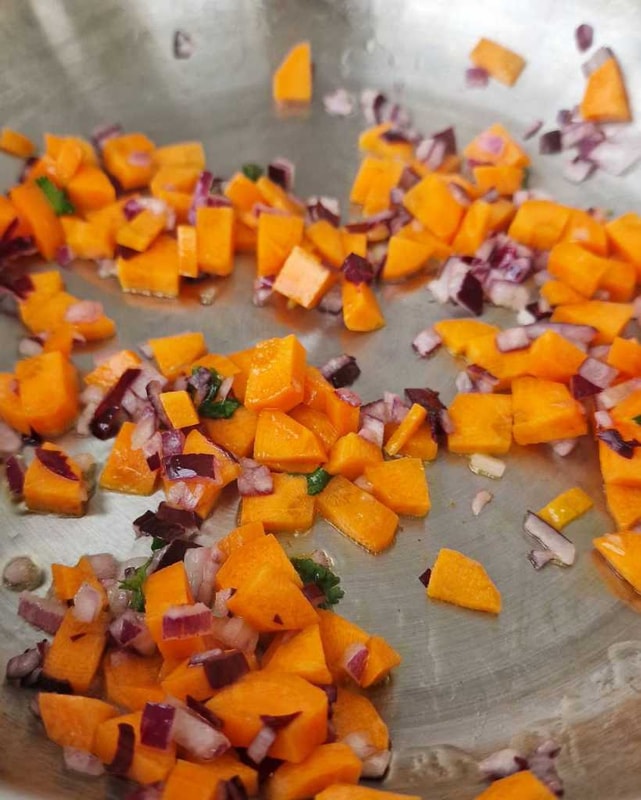 Chopped onion and carrots in a pot