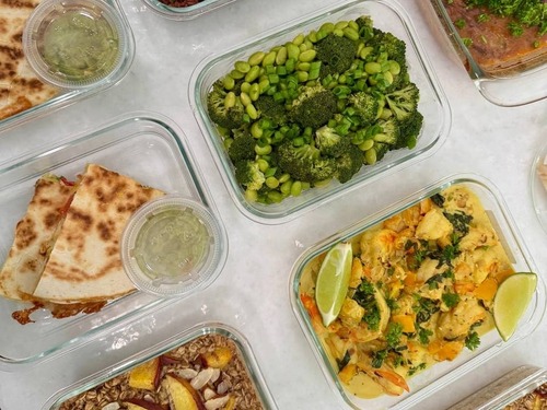 Two oat bakes in front, coconut shrimp and folded naan waiting at the back of the counter.