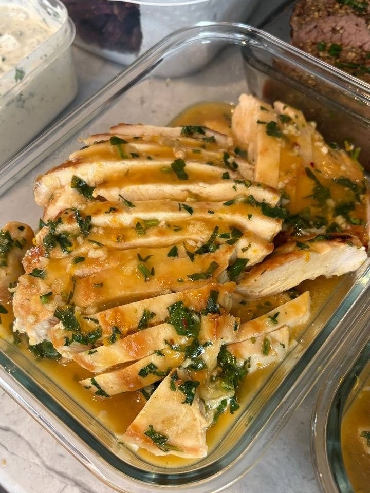 glass container filled with chicken and herb