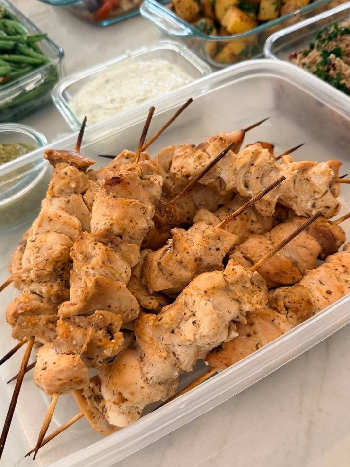 plastic container filled with marinated chicken skewers