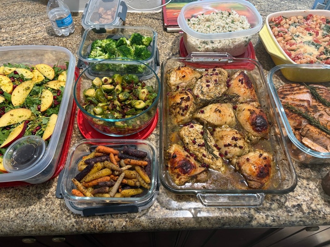 Overhead view of winter harvest meal prep, including roasted chicken and sides.