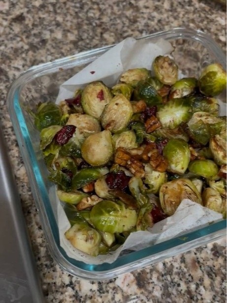 Roasted Brussels sprouts with cranberries and walnuts in a glass container