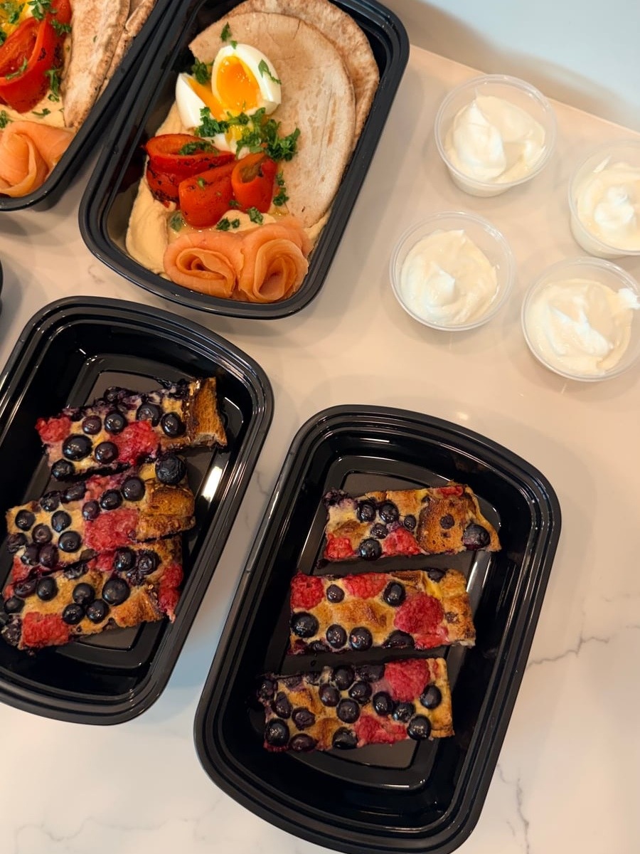 The selection includes balanced breakfast bowls featuring smooth hummus, tender smoked salmon, protein-rich boiled eggs, and toasted pita triangles.