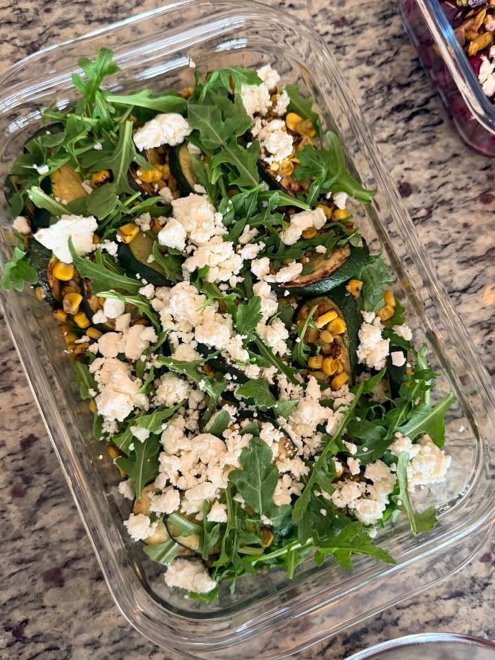 Charred corn and zucchini salad with peppery arugula and crumbled feta, highlighting fresh ingredients for healthy home-cooked meals.