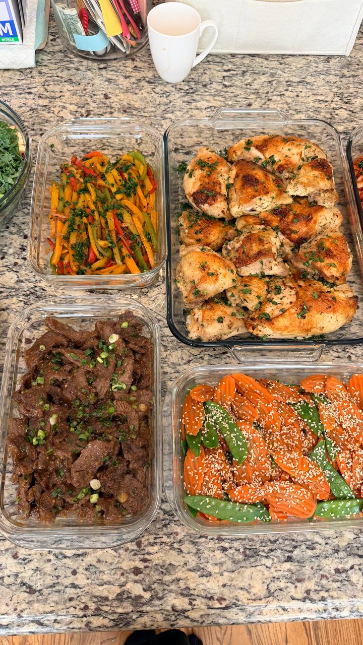 Four glass containers featuring Greek lemon chicken, teriyaki beef with scallions, fajita-style bell peppers, and stir-fried carrots and snow peas with sesame seeds.