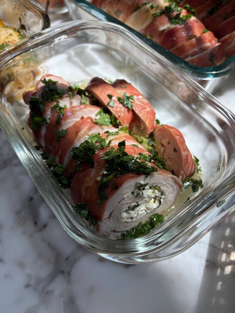 Artfully sliced feta and herb stuffed turkey tenderloins, perfect for high-protein meal prep delivered to homes in the Houston Energy Corridor and surrounding areas.
