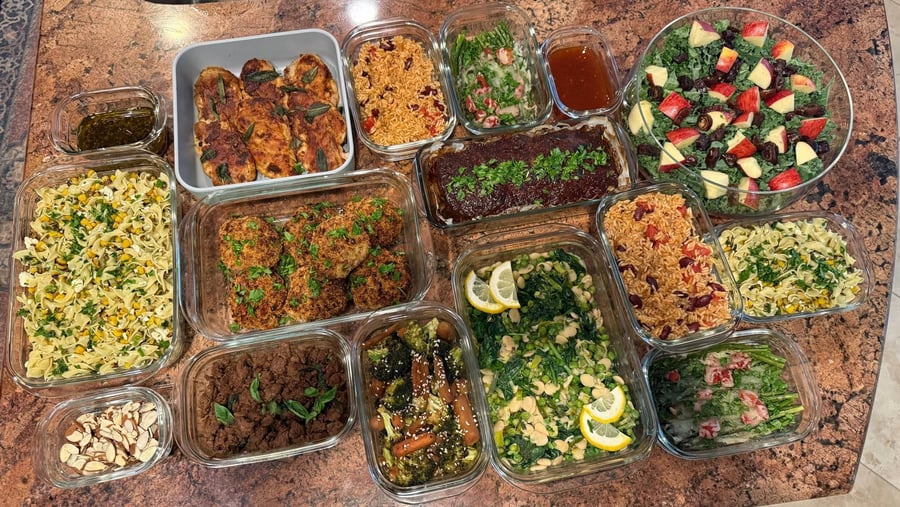 Every dish of the delivery angled across stone: Spanish rice, kale apple salad, meatloaf, saltimbocca.