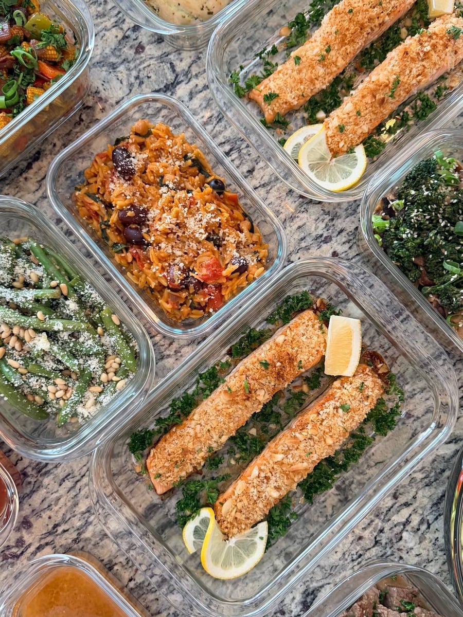 Macadamia crust runs the length of two salmon fillets, lemon wheels curled at either end.