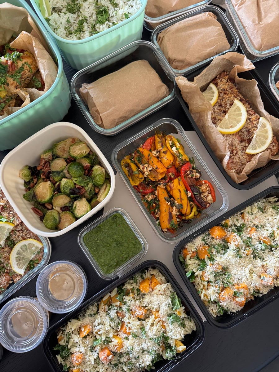 Pecans and dried cranberries fall between the seared Brussels sprout halves, chimichurri green in its tub.