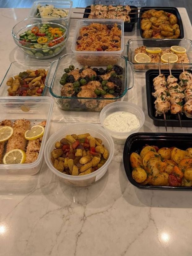 The whole delivery covers the counter, skewers and macadamia salmon at the centre, potatoes at either end.