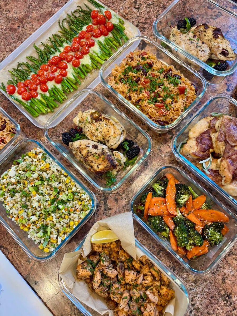 Blackberries and jalapeno slices surround stuffed chicken beside Spanish rice, saltimbocca, roasted vegetables and salmon.