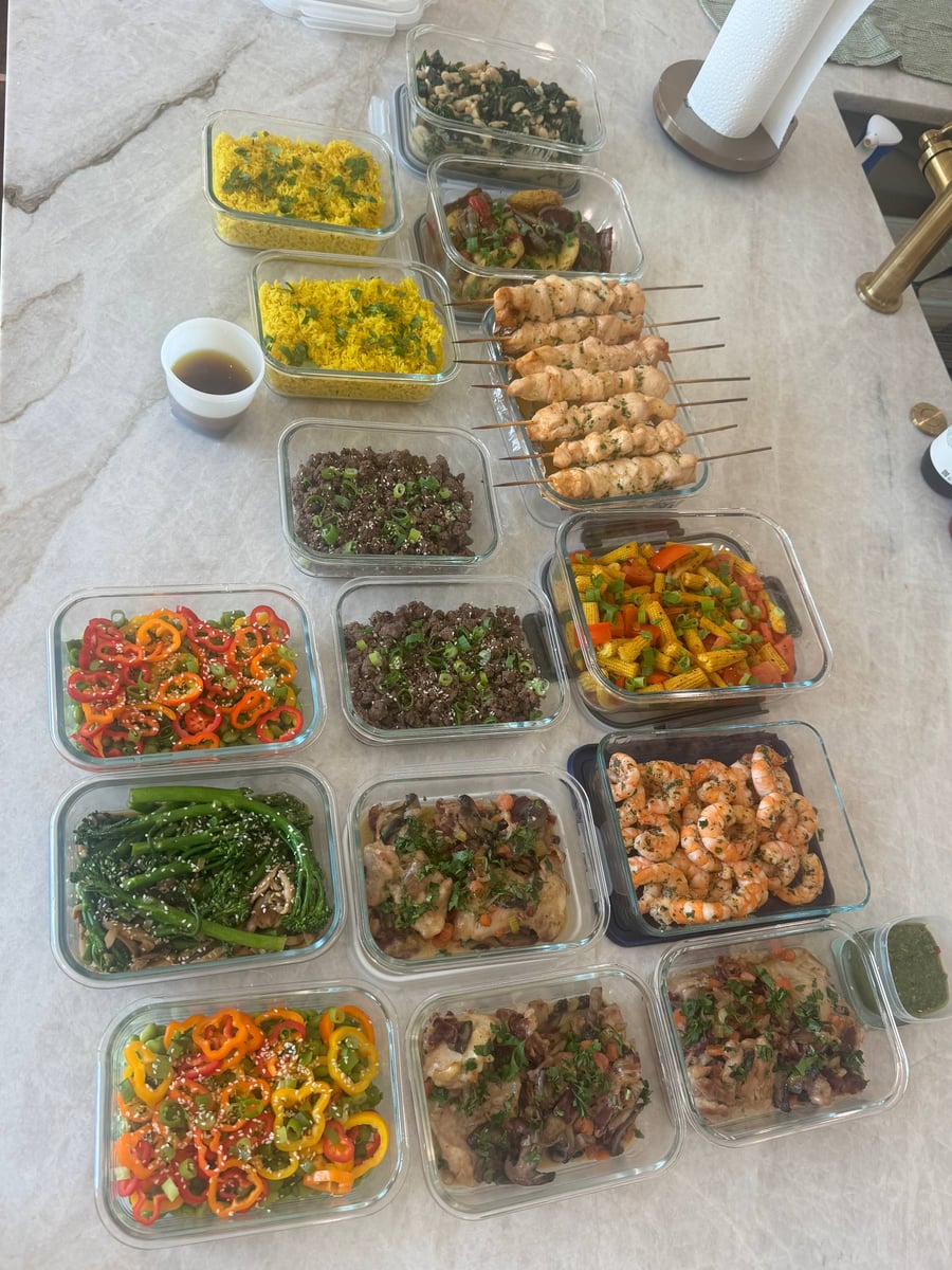 Chicken skewers and chimuchuri shrimp anchor a full spread of turmeric rice, Korean beef, coq au vin and vegetables.
