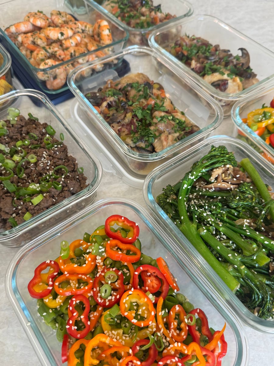 Edamame and pepper salad fills the foreground beside sesame broccolini, mushroomy coq au vin, Korean beef and shrimp.