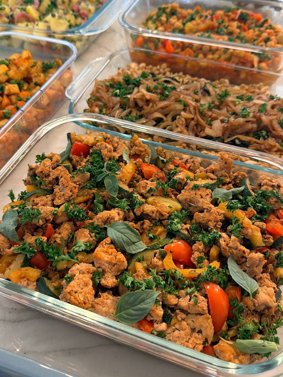 Basil and parsley cover the ground turkey, zucchini coins and red pepper folded right through it.