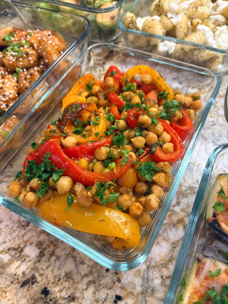 Red and yellow pepper strips curl around cumin-baked chickpeas, chopped parsley and browned onion pieces.
