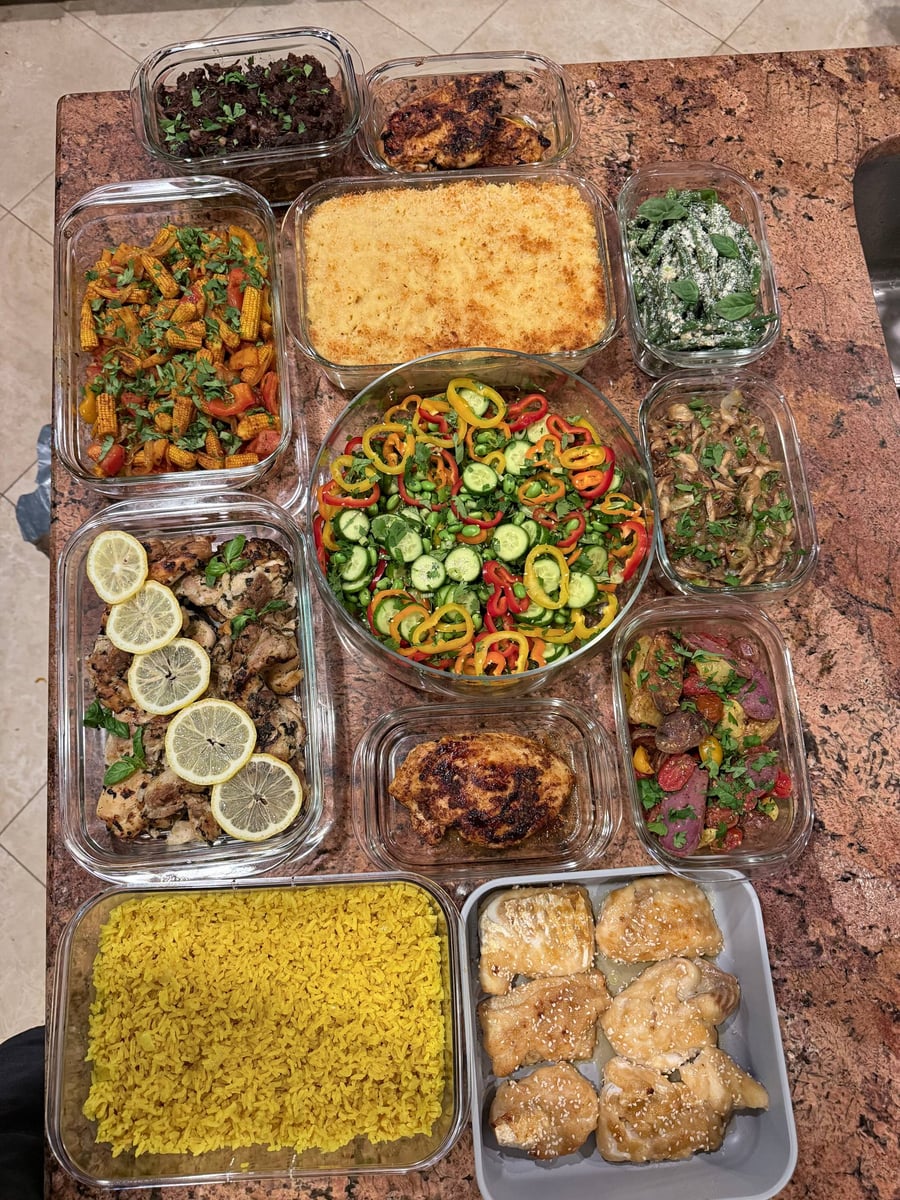Colorful edamame salad fills the center among baked macaroni, baby corn, lemon chicken, seared breast and chuck roast.