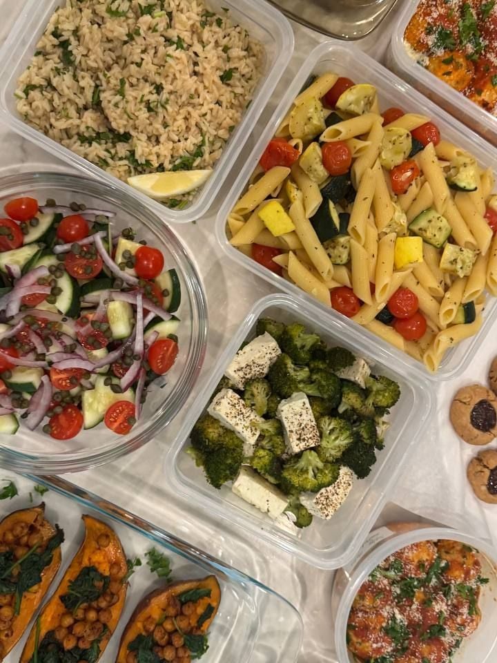 Lemon wedges tuck into the herby brown rice, penne with zucchini and cherry tomatoes alongside.