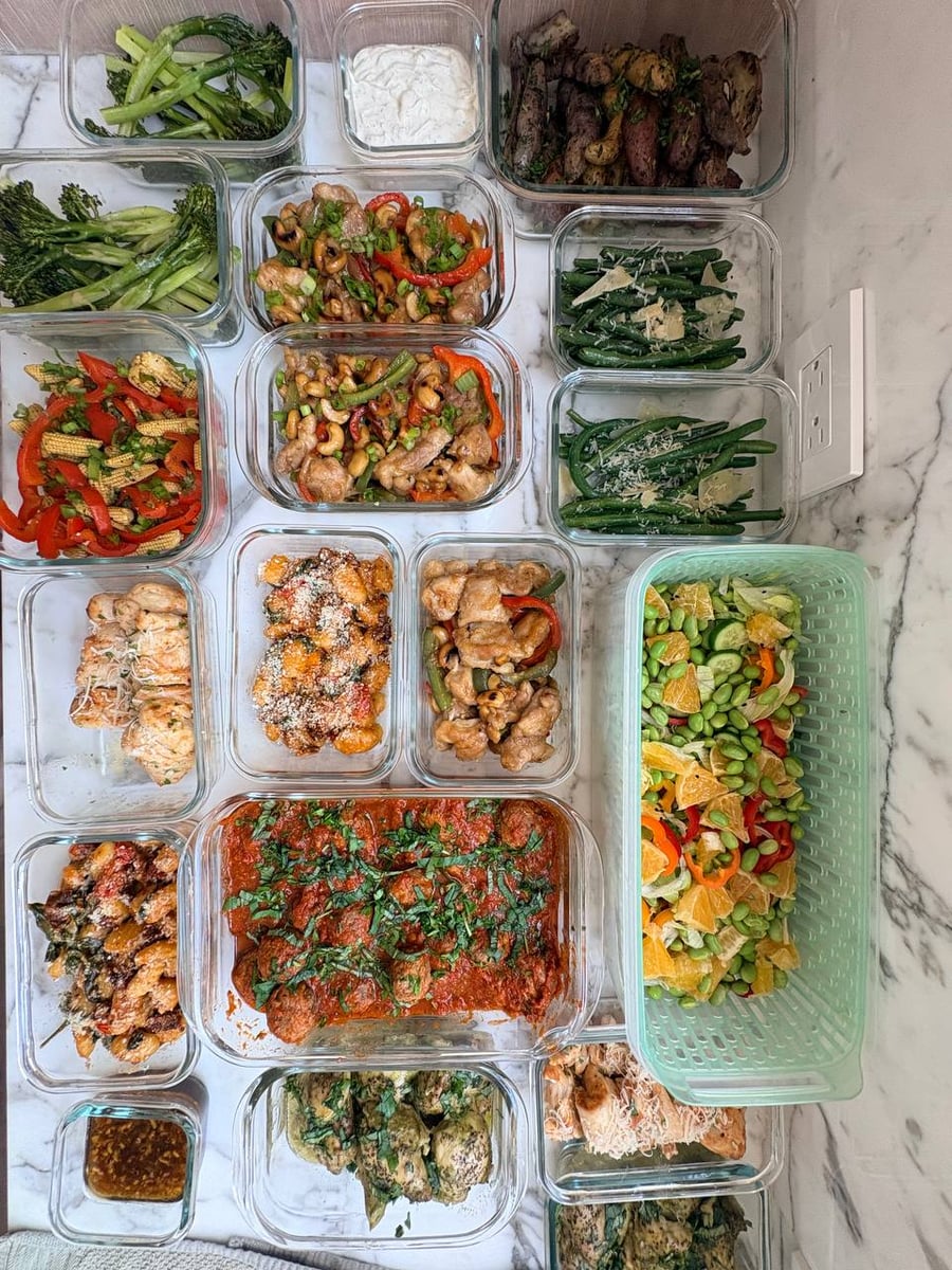 Toasted cashews and scallions cover chicken bites with red pepper, while Parmesan shards top green beans beside them.