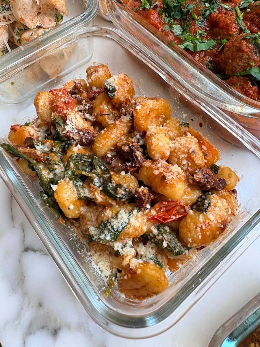 Golden Marry Me gnocchi mingle with wilted spinach, sun-dried tomatoes and a fine savory crumble.