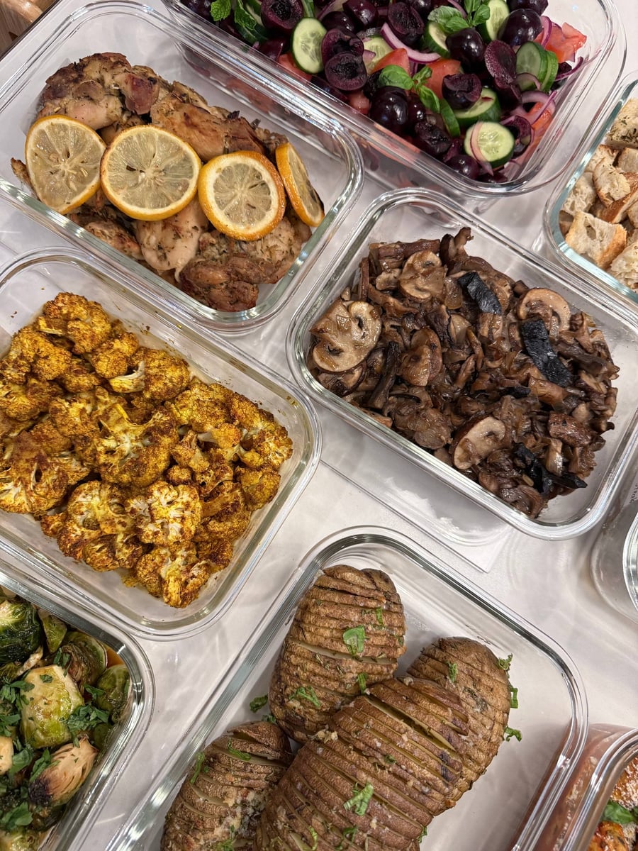 Lemon slices cover herb-baked chicken thighs beside dark sautéed mushrooms, Moroccan cauliflower and Hasselback potatoes.