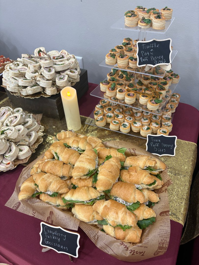 Display of cranberry turkey croissants, tuna puff pastry bites, and truffle pate puff pastry bites.