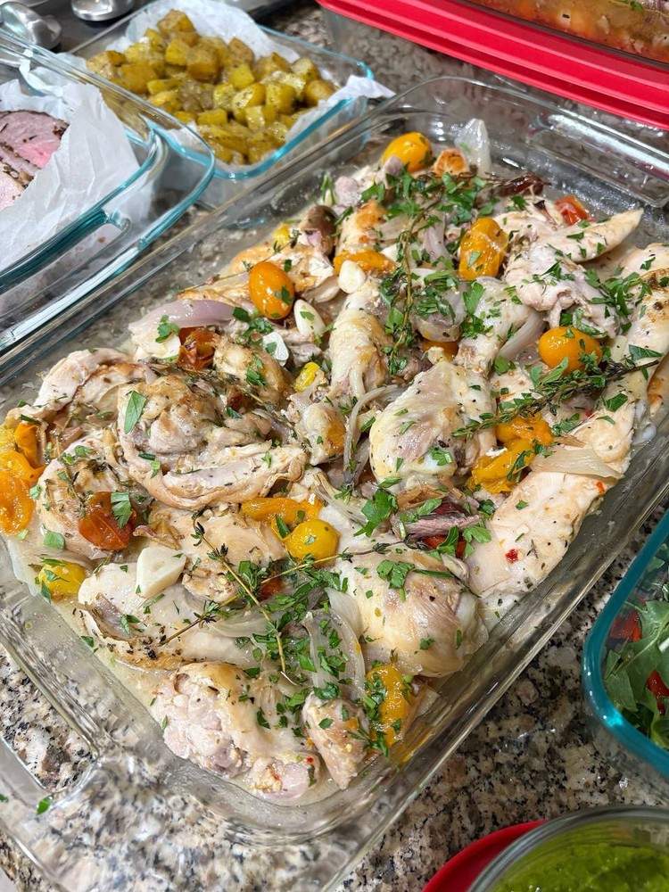 Roasted chicken with cherry tomatoes, onions, and fresh herbs.