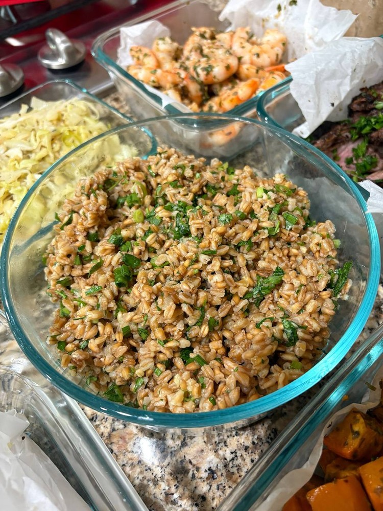 Bowl of farro with fresh herbs, ready for meal prep.