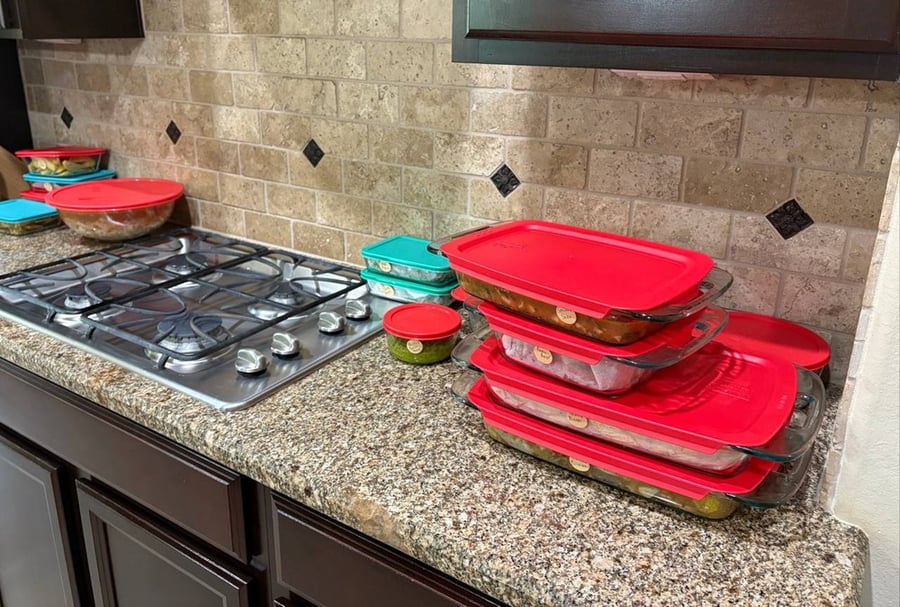Packaged meal prep containers stacked on the kitchen counter.