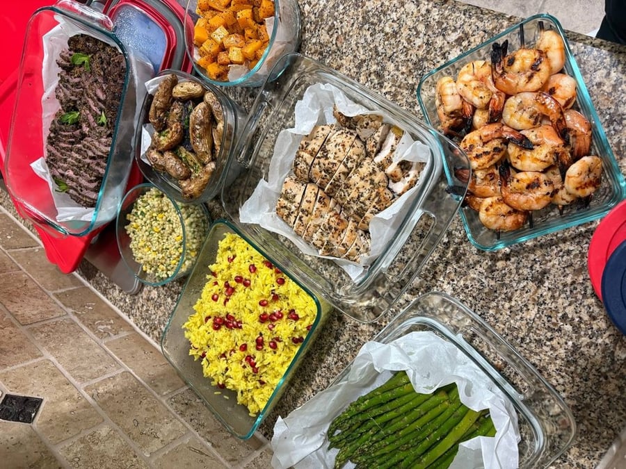 Assortment of meal prep dishes in glass containers on a countertop