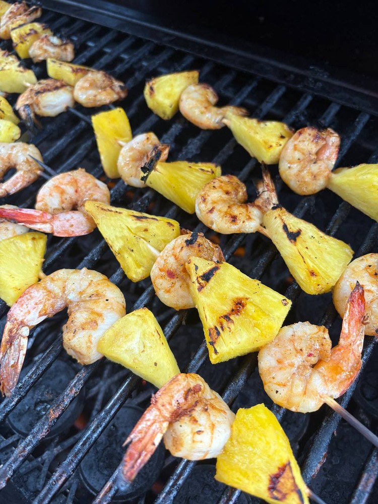 Grilled shrimp and pineapple skewers cooking on the grill