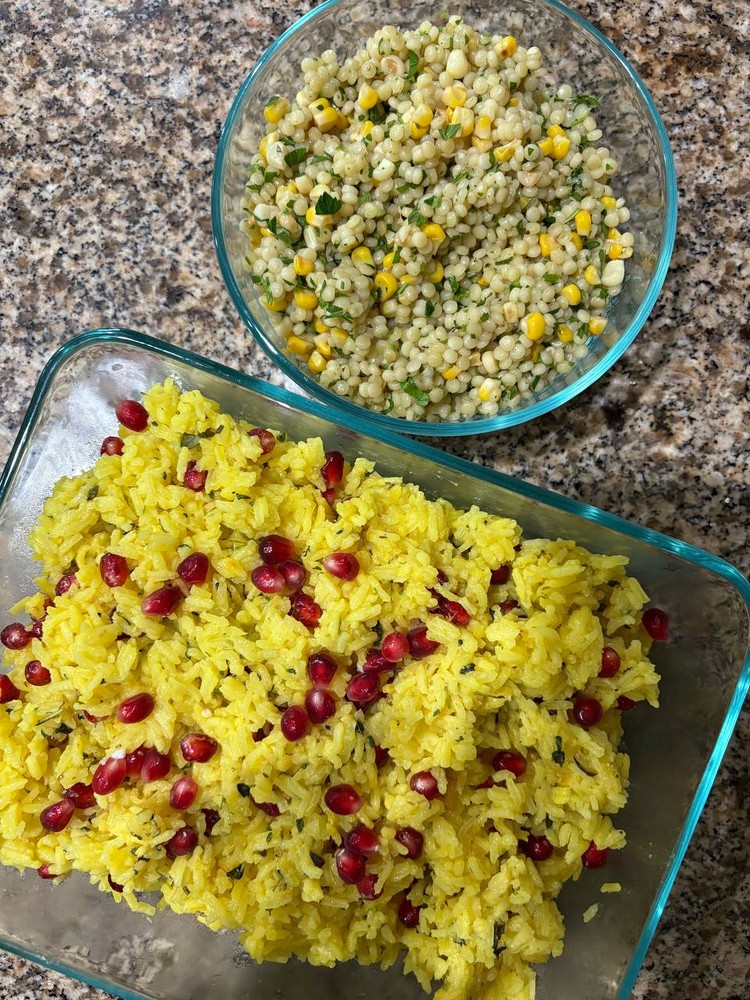 Yellow rice with pomegranate and couscous salad with corn