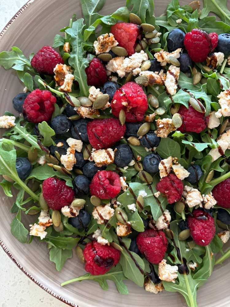 Arugula, berry, feta, and pumpkin seed salad with balsamic glaze