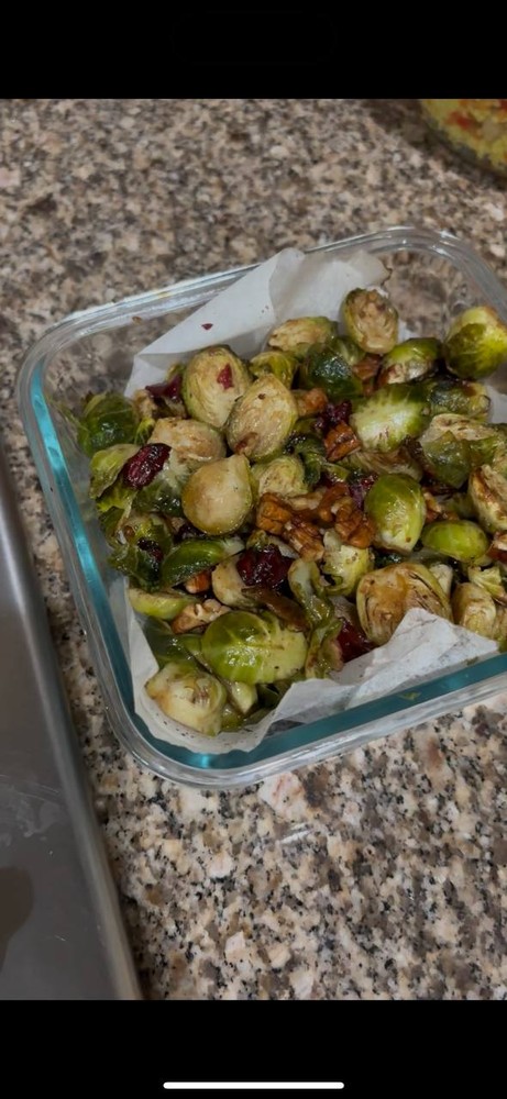 Roasted Brussels sprouts with cranberries and walnuts in a glass container