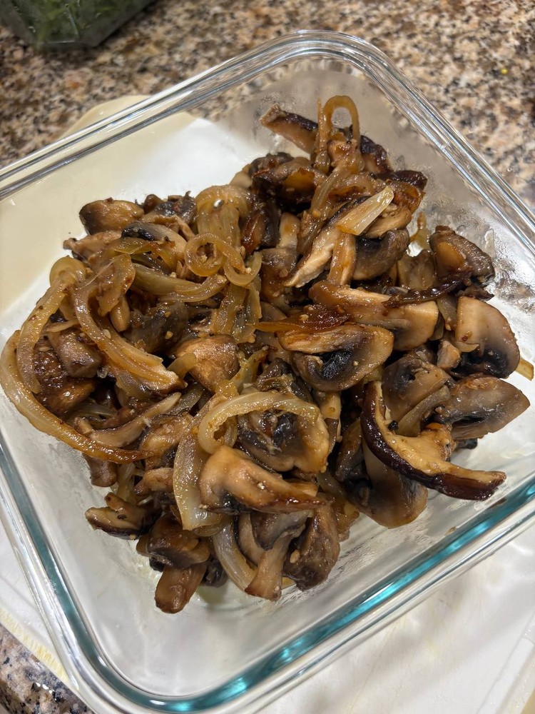 Sautéed mushrooms and onions in a clear glass container