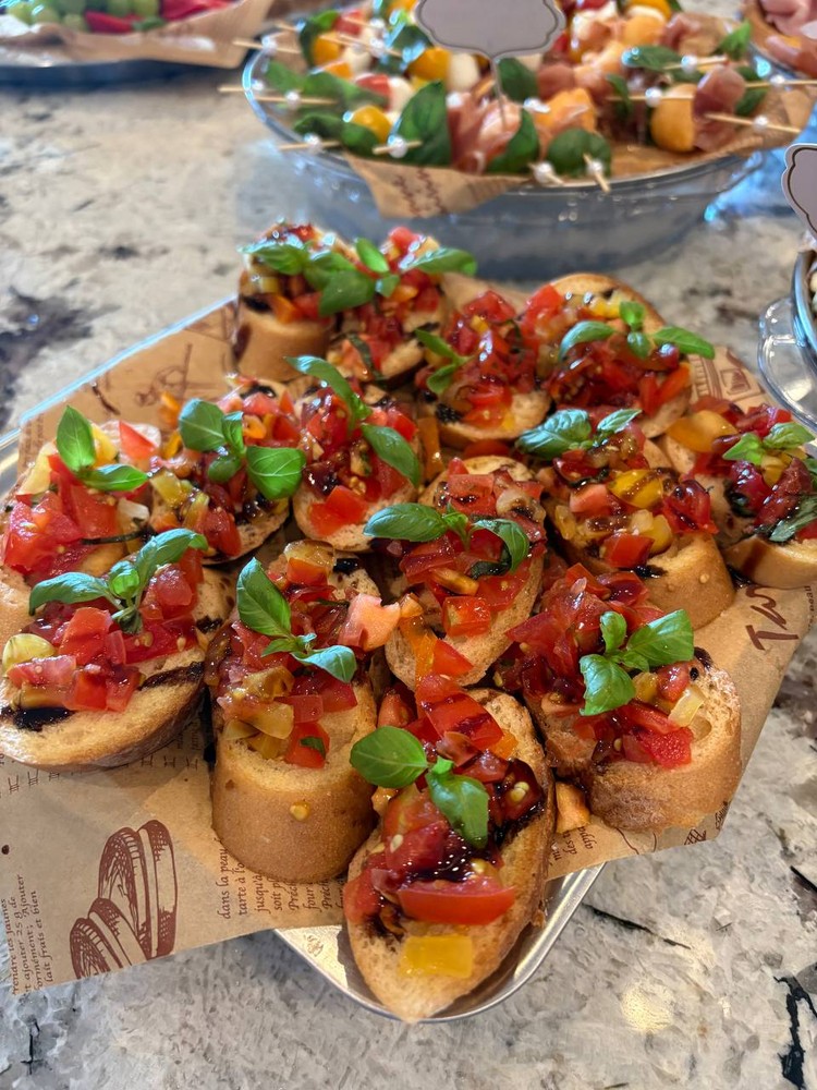 Tomato basil bruschetta with balsamic glaze on baguette slices.