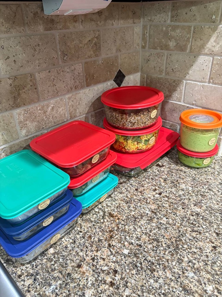 Assortment of prepped meals in colorful storage containers
