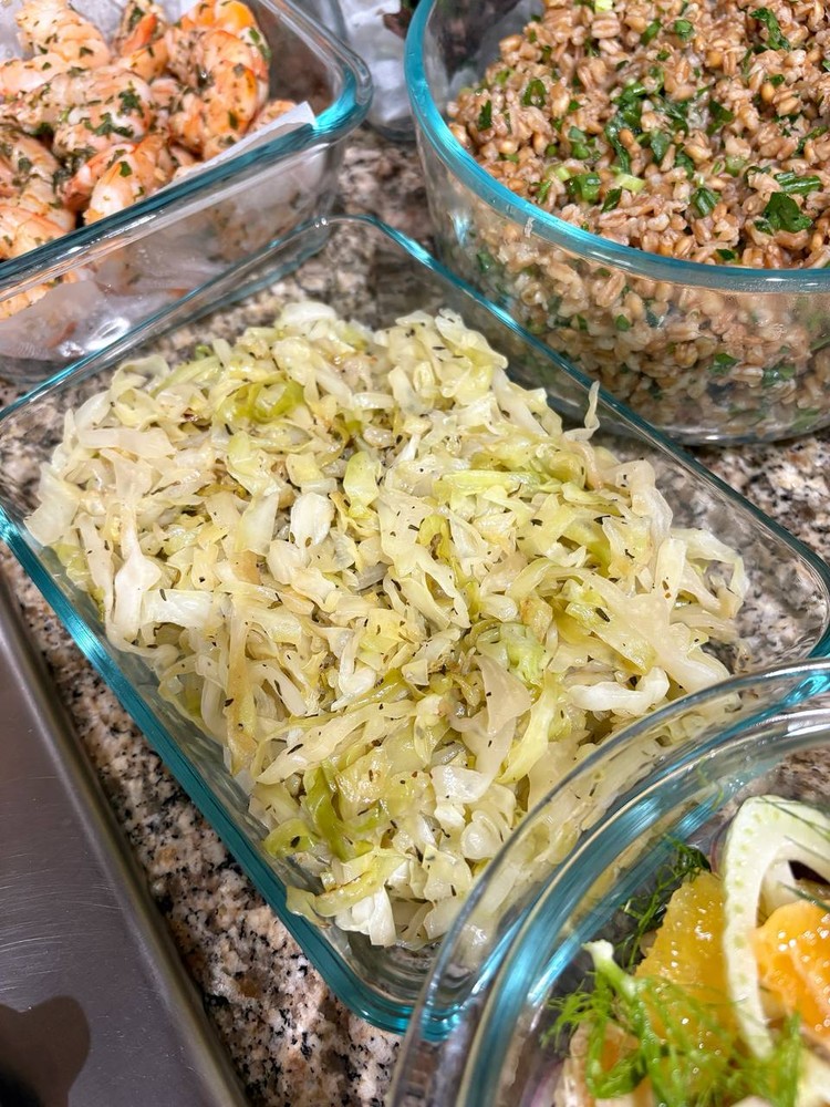 Sautéed cabbage with herbs and spices in a glass container.