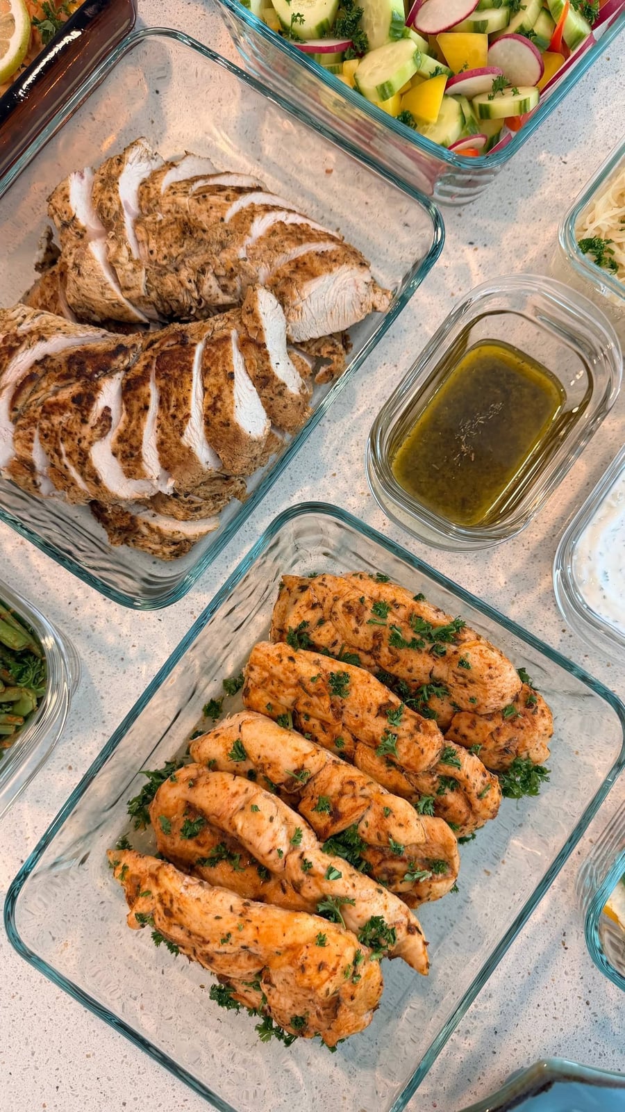 Four fish fillets baked with lemon wheels and parsley, the skin side down in a shallow dish.