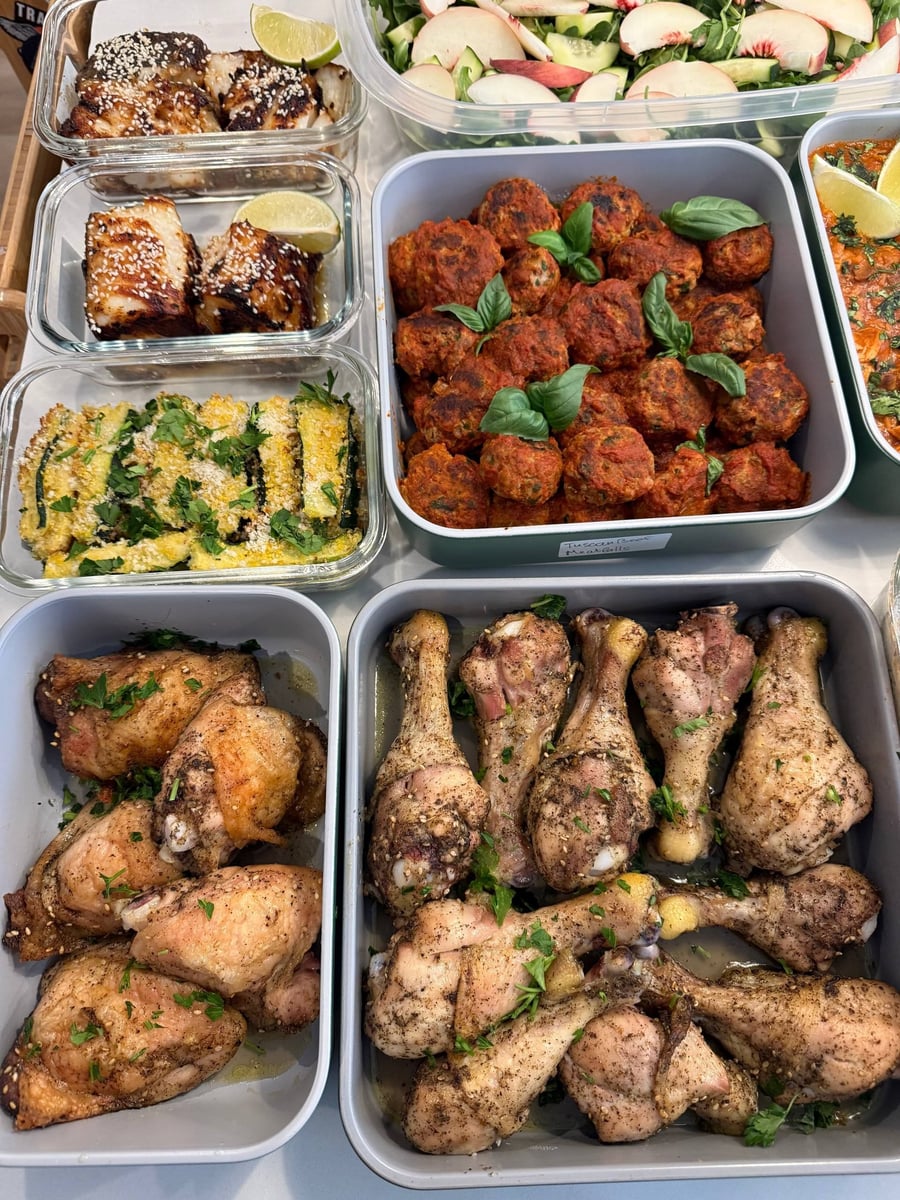 Zaatar dusts baked chicken drumsticks in two trays, sesame-topped miso halibut and zucchini sticks below.