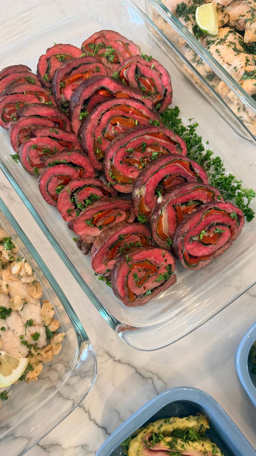 Each slice shows a spiral of spinach, roasted bell pepper and melted mozzarella through medium rare beef.