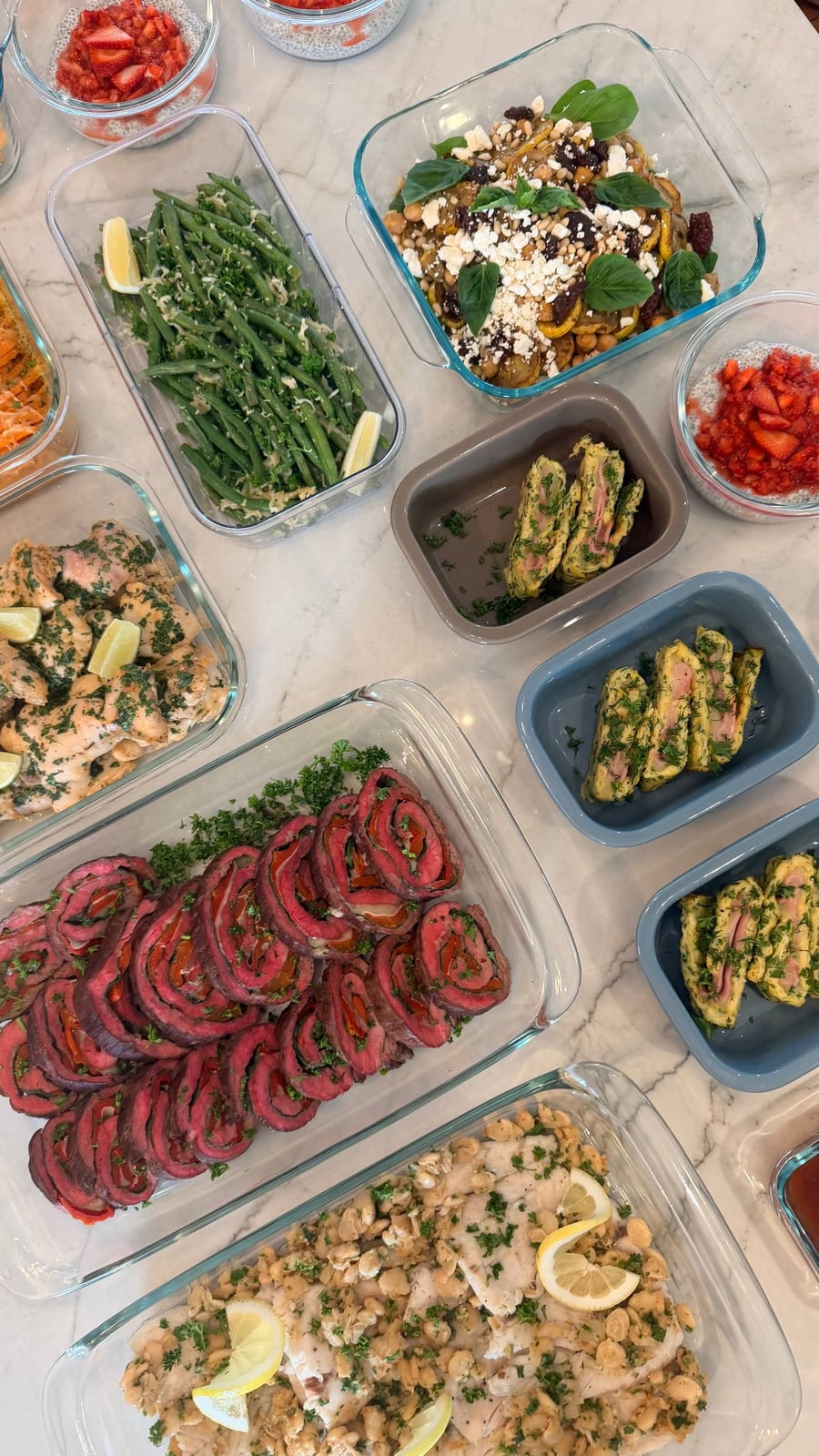 Flank steak pinwheels spiral red and green beside honey lime chicken, egg wraps and chia puddings.