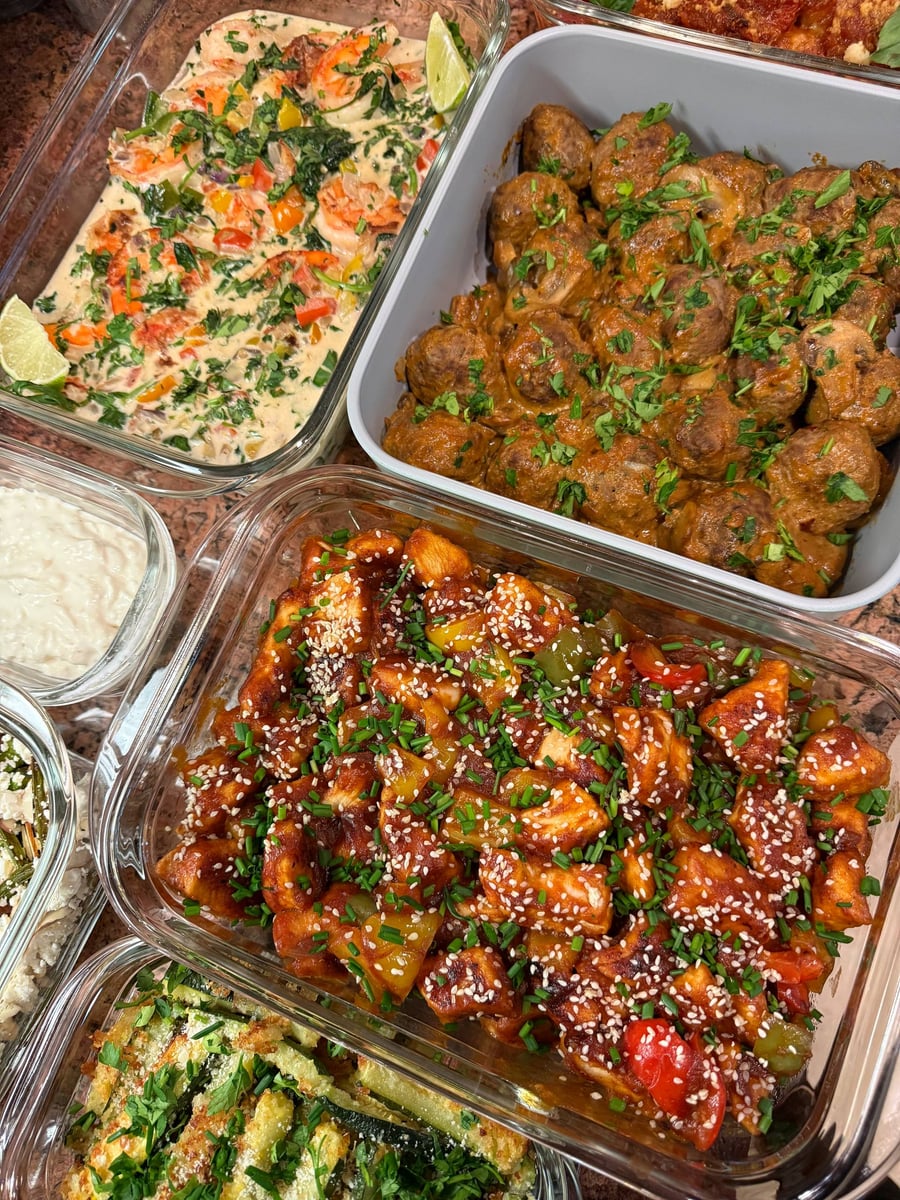 Sesame seeds and chives cover sweet and sour chicken, coconut shrimp and stroganoff meatballs above.
