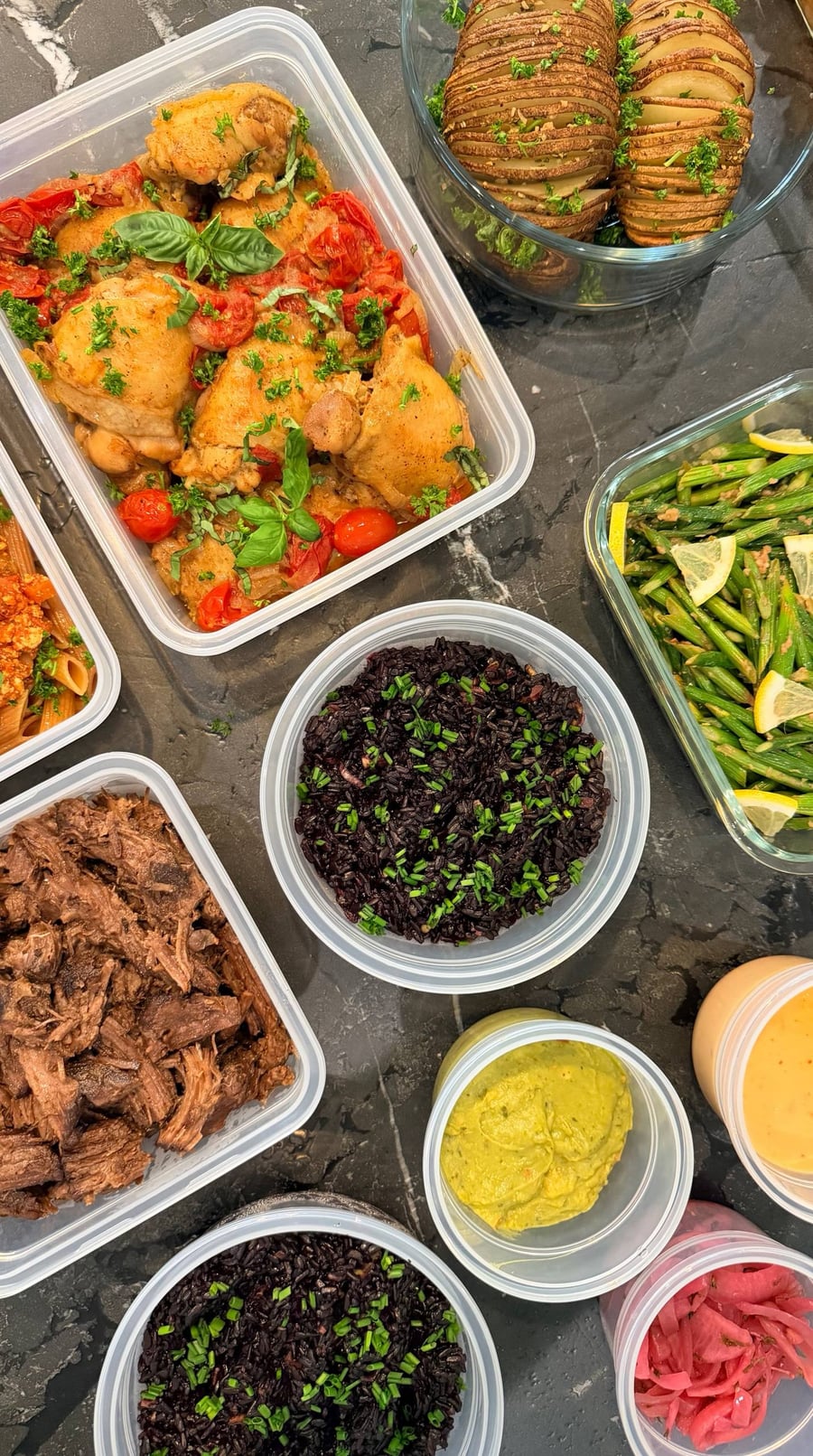 Mexican shredded beef pulls apart in long strands beside black rice, guacamole and a jar of pink pickled onion.