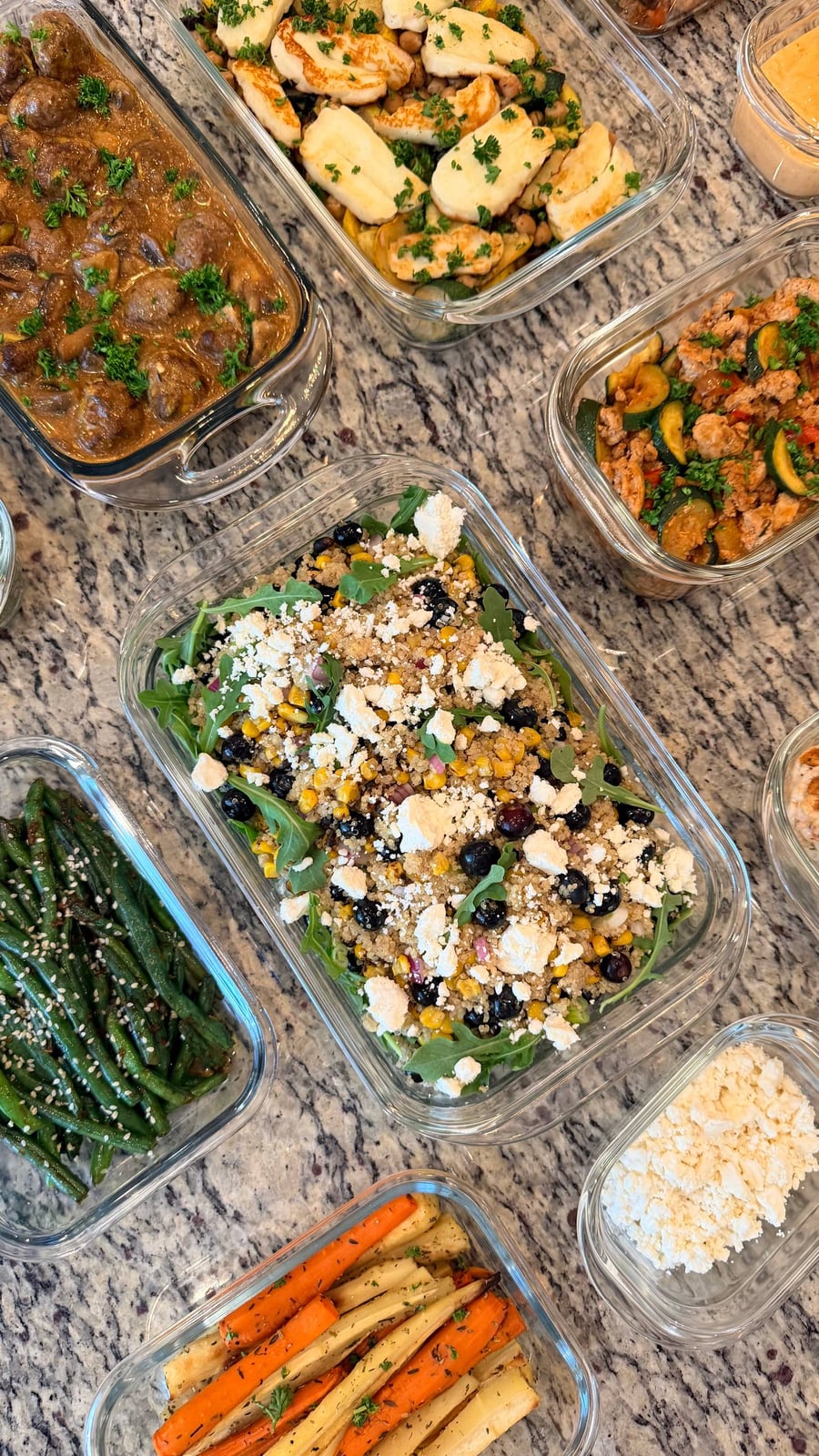 Blueberries and charred corn stud quinoa under crumbled feta, arugula pushing through at the edges.