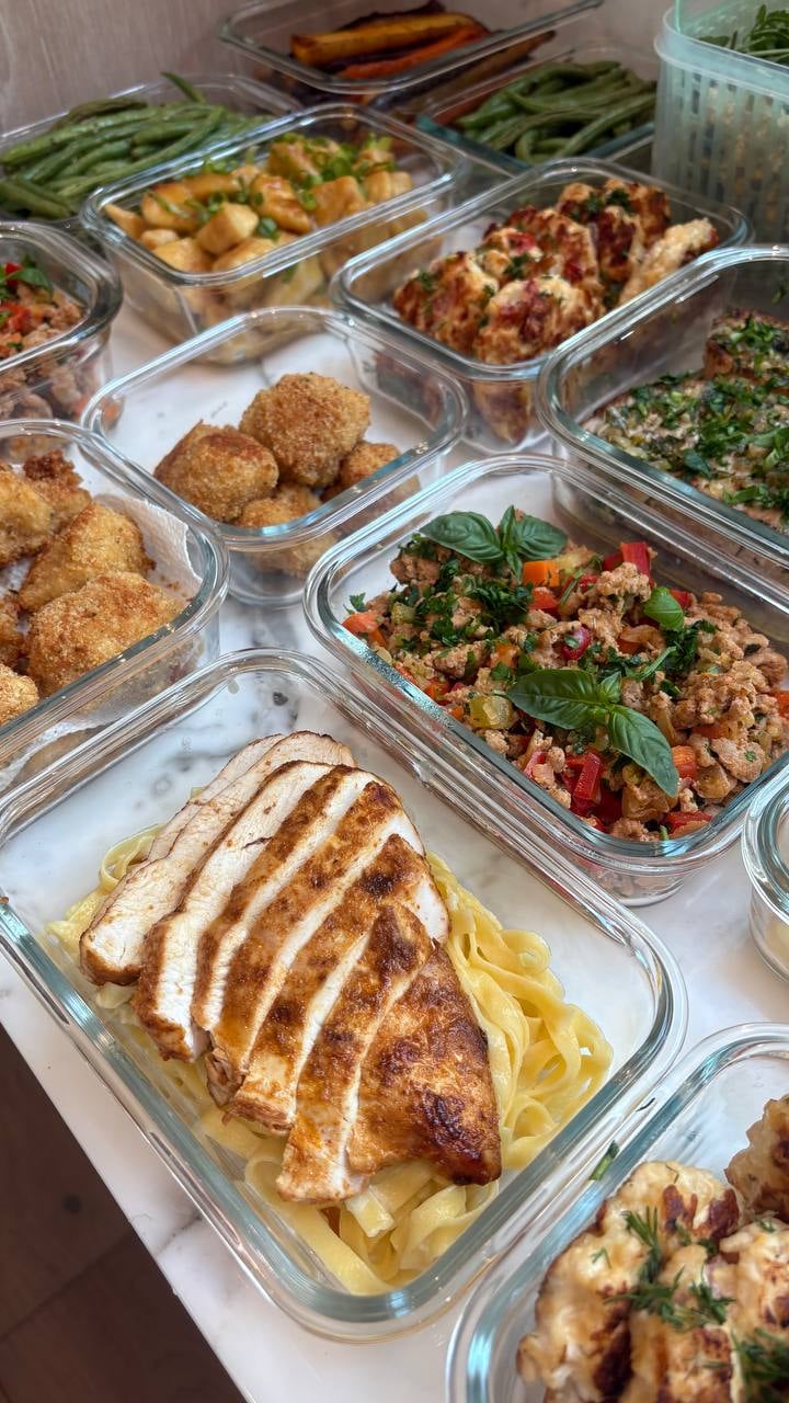 Sliced seared chicken fans over fettuccine alfredo, breadcrumbed cauliflower and ground turkey stacked behind.