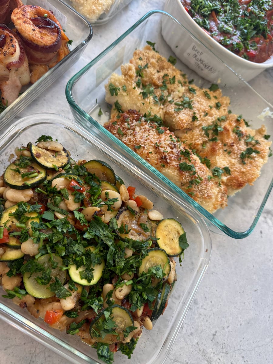Zucchini coins and braised white beans carry red pepper and a thick layer of chopped parsley.