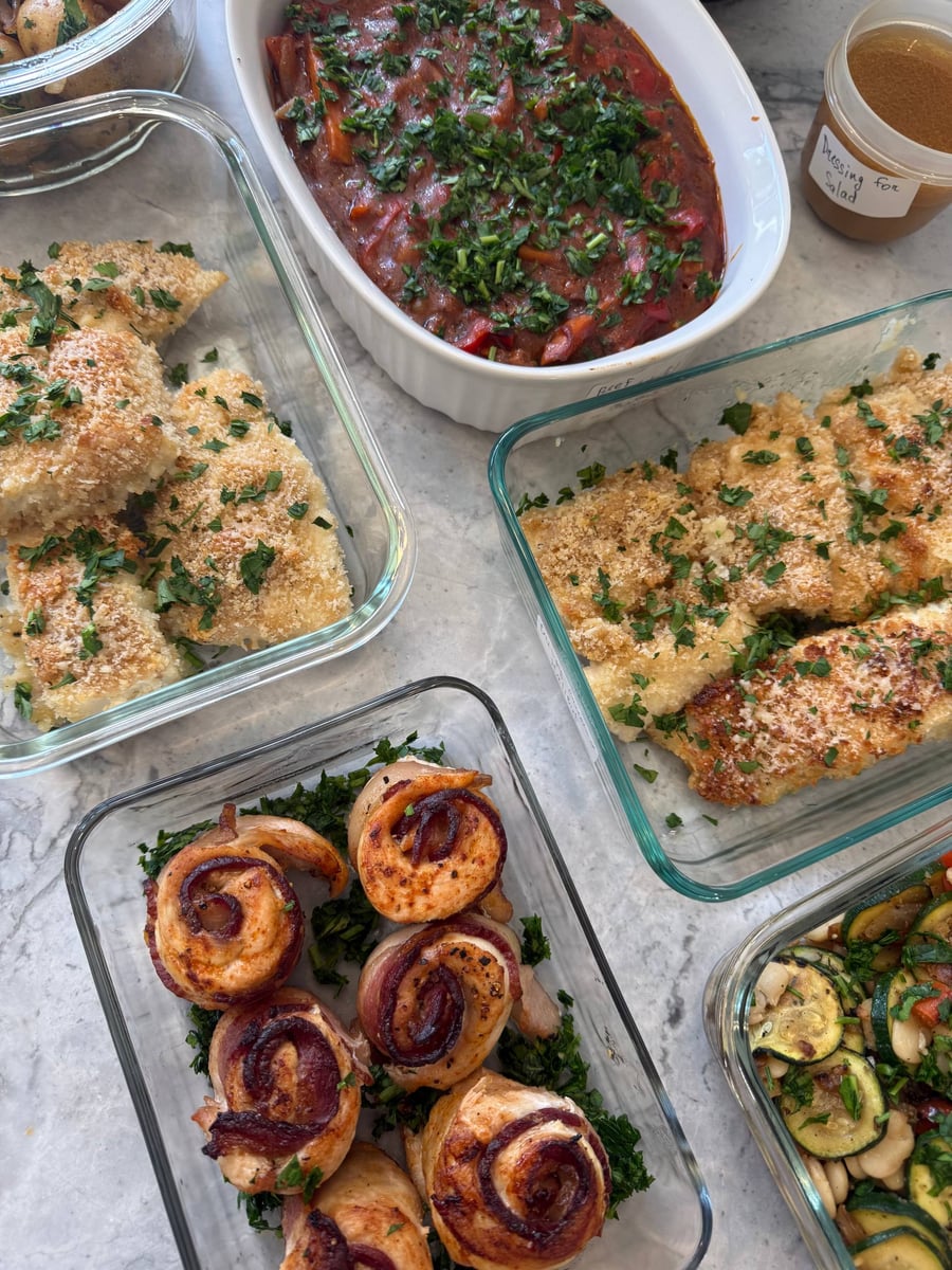 Panko crust bakes golden over garlic herb halibut filets, parsley scattered across, with chicken rounds below.