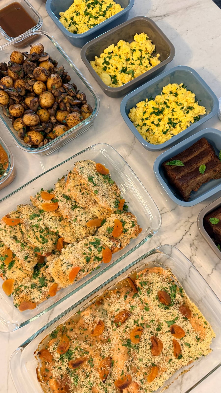 Dried apricot halves tuck into a herbed crumb over baked chicken breasts, scrambled eggs alongside.