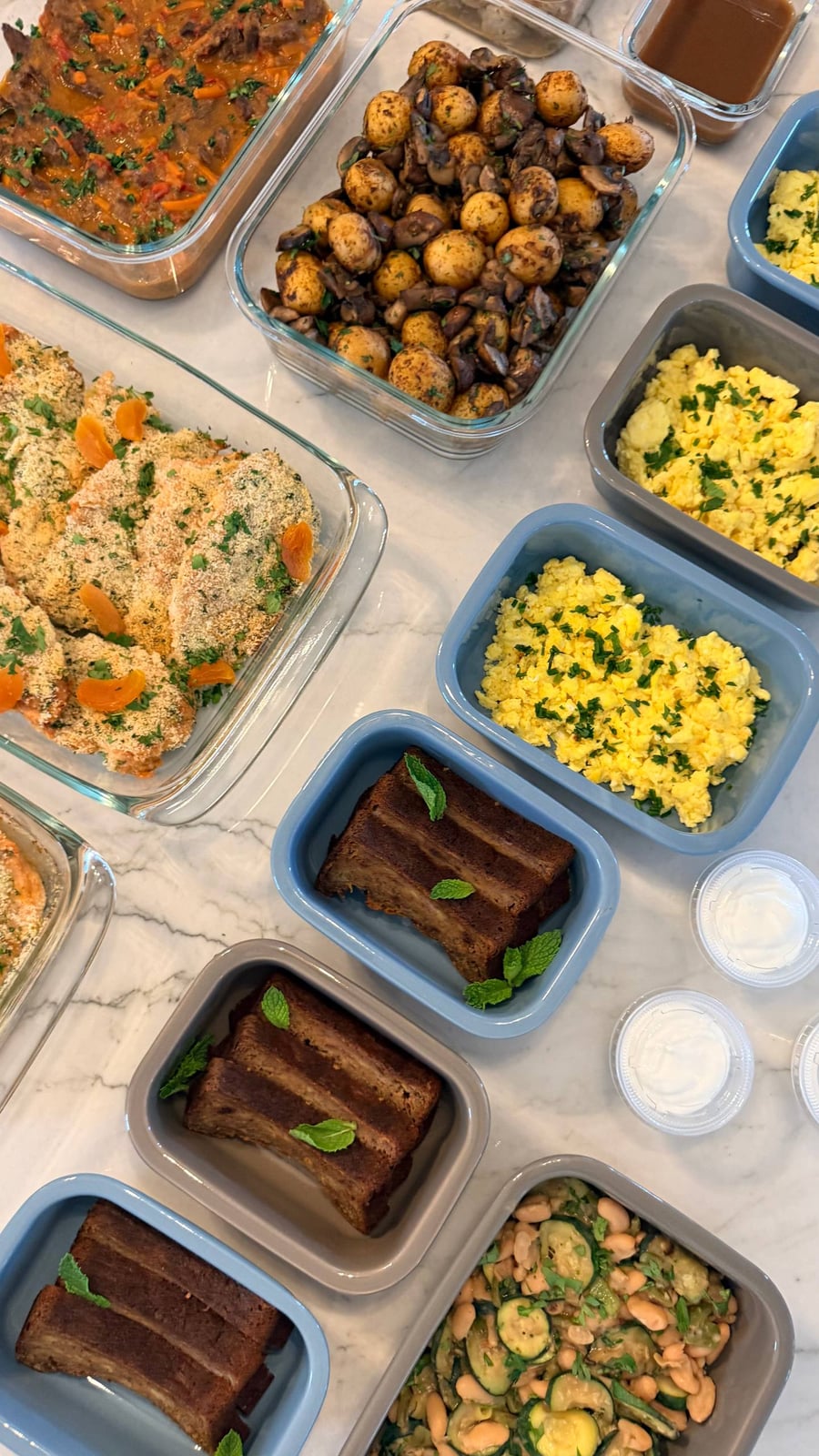 Mint leaves top thick slices of protein banana bread, set beside chive scrambled eggs and mushroom potatoes.