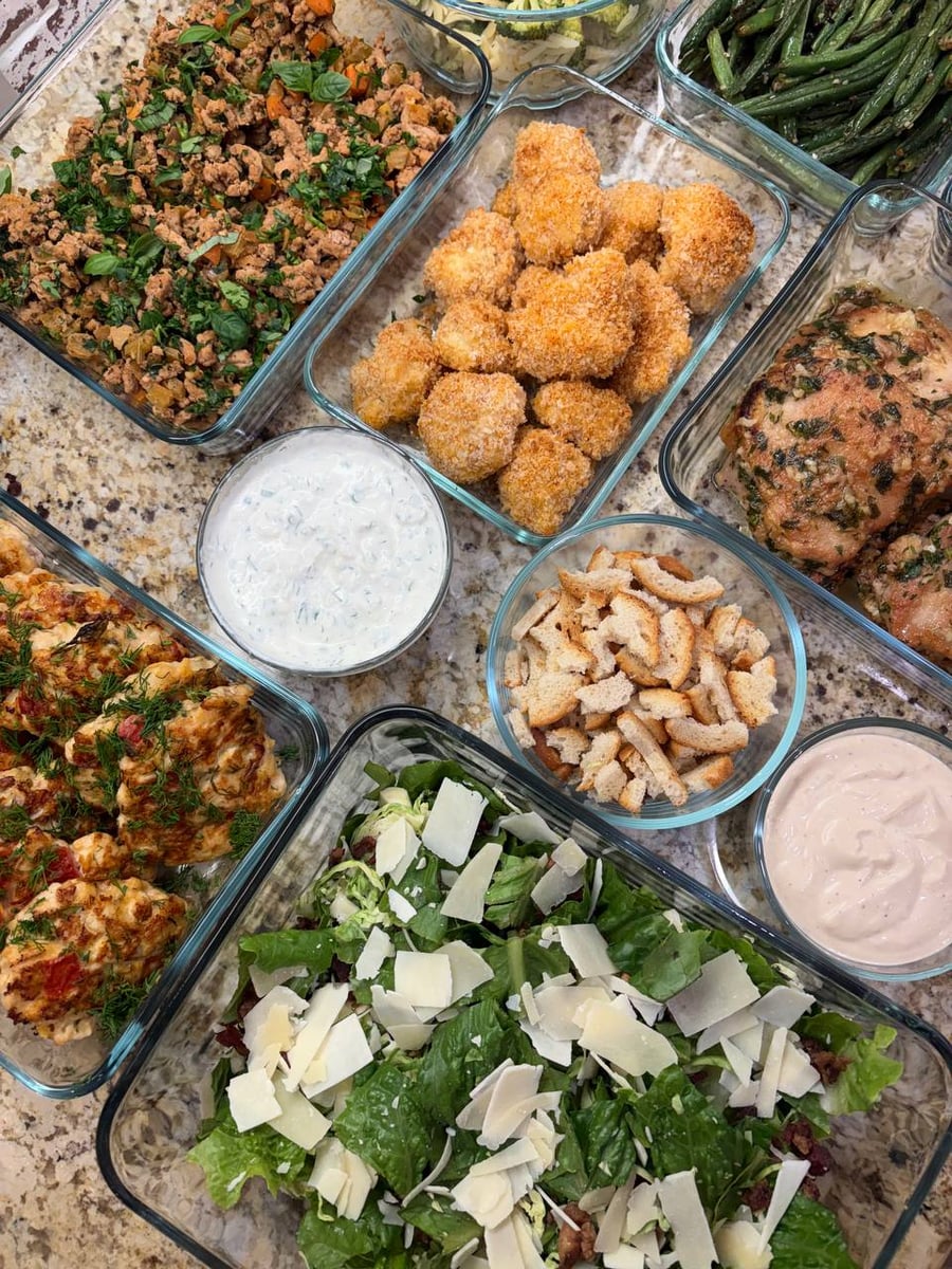 Shaved parmesan falls over romaine and brussels, with dill chicken patties and panko cauliflower alongside.